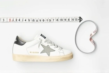 Golden Goose sneaker with measuring tools for size accuracy.