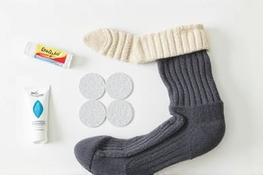 Items for preventing shoe blisters: balm, pads, socks.