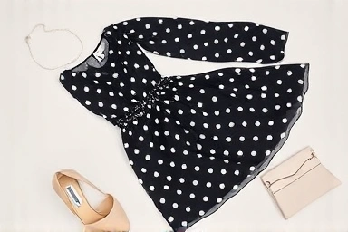Chic polka dot dress flat lay with accessories.