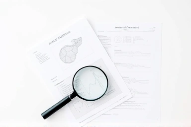 Medical documents and magnifying glass symbolizing insurance claim analysis.