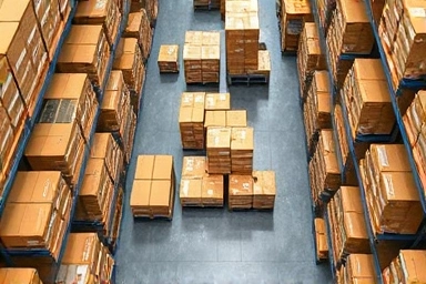 Neatly stacked product boxes in an organized stockroom.