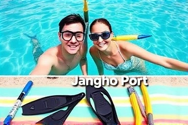 Snorkeling couple above water, gear laid out below.