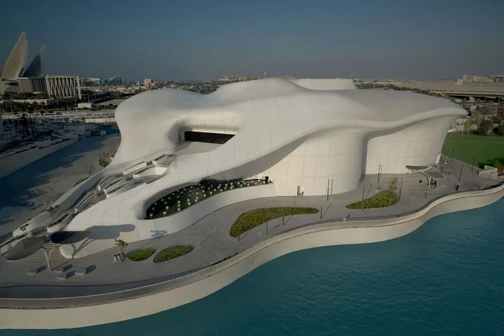 White sculptural building, modern waterfront architecture.