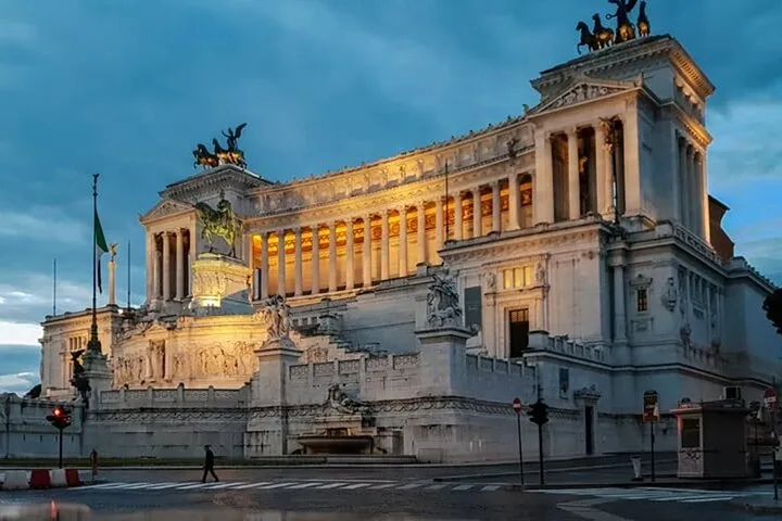 Vittoriano monument illuminated at dusk in Rome.