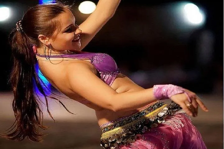 Belly dancer performs on stage.