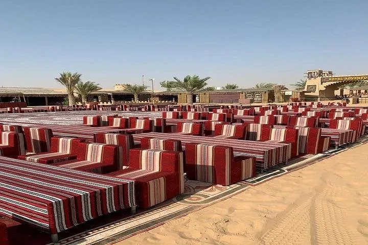 Desert seating area with red-striped cushions.