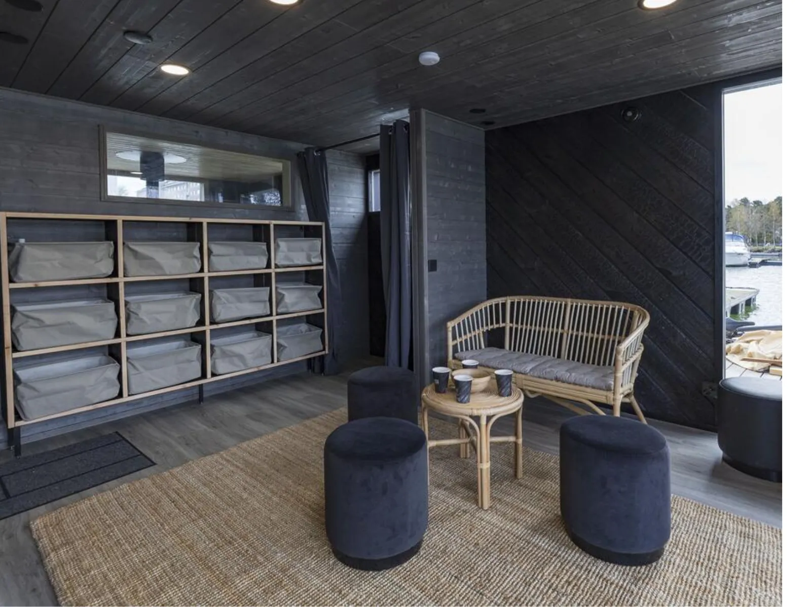 Contemporary living room with rattan sofa, water view.