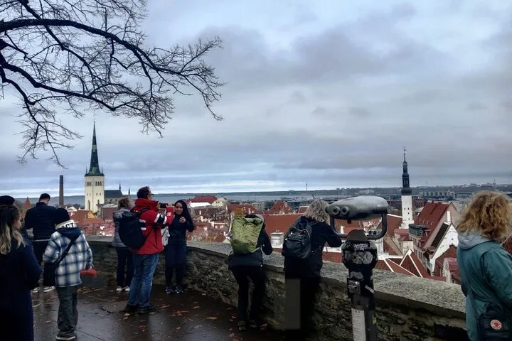 Tourists at Tallinn Old Town cityscape viewpoint.