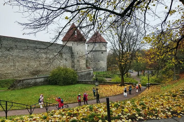 Tallinn Old Town castle, autumn park, tourists.