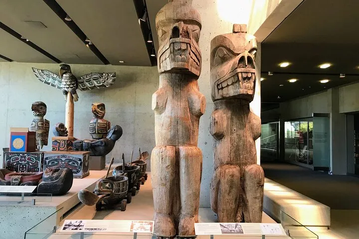 Indigenous totem poles and carvings in museum.