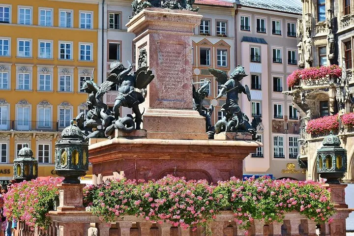 Munich monument with cherub statues and pink flowers