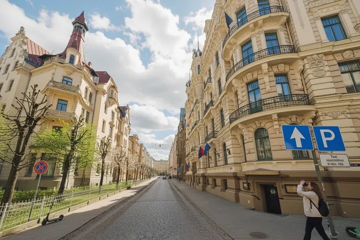 Ornate Art Nouveau buildings lining European street.