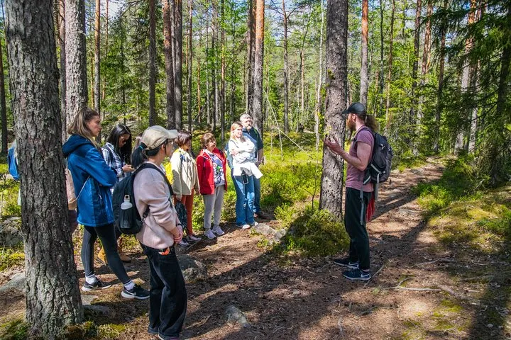 Guide leading group on forest nature walk.
