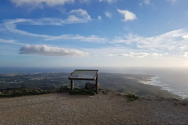 Viewpoint sign with panoramic ocean and city.