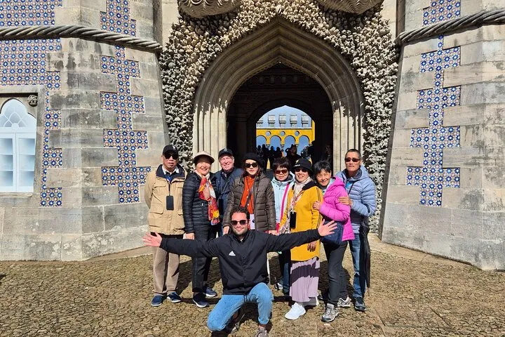 Tourists at Quinta da Regaleira palace entrance.