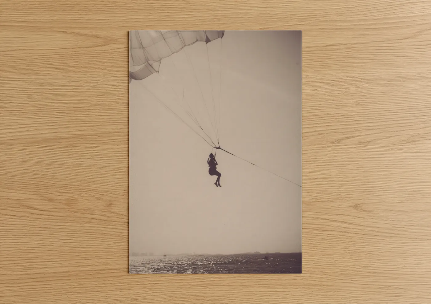 Art print on warm oak wood — beige and gray palette — Coastal Parasailing poster