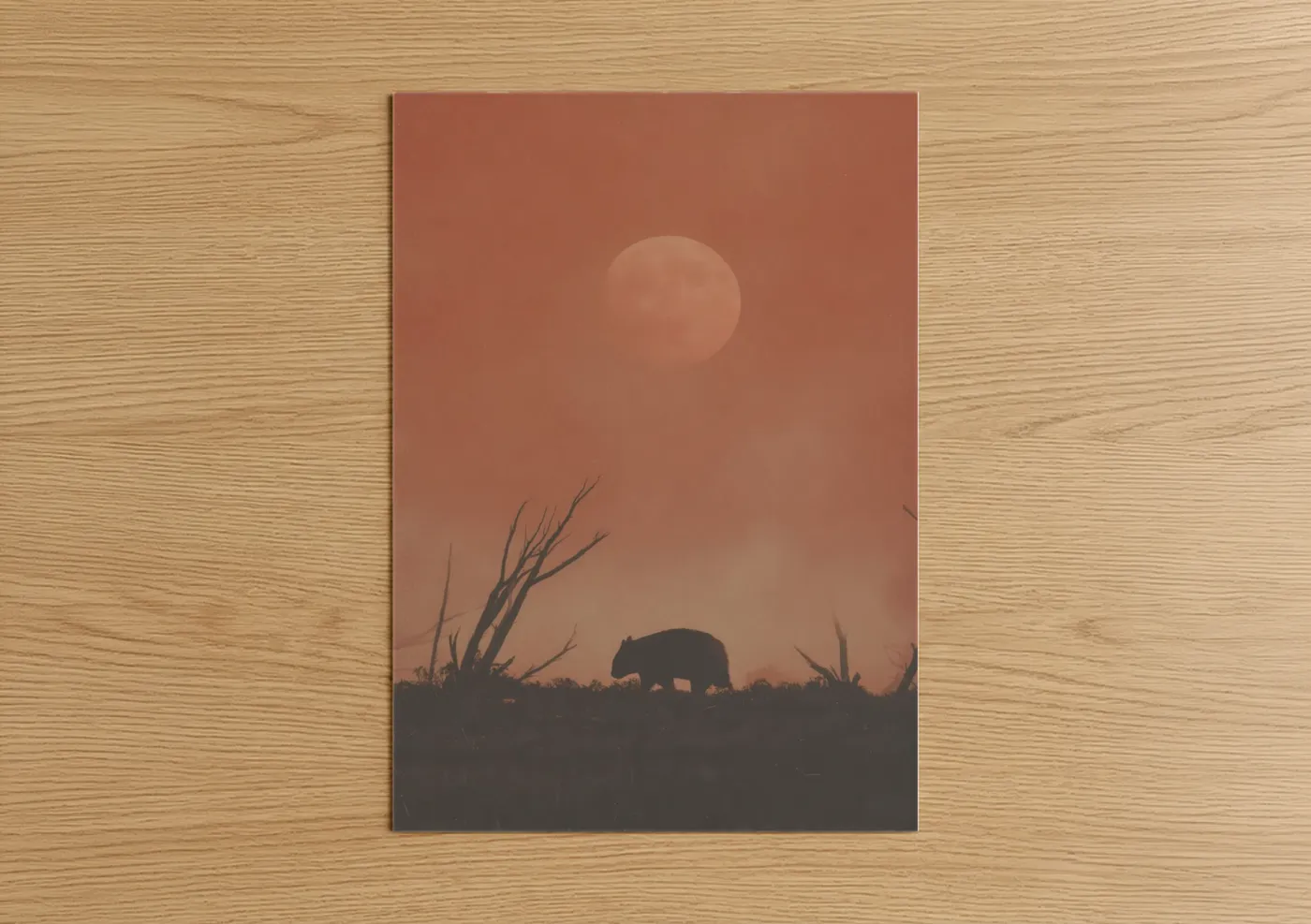 Art print on warm oak wood — russet and peach palette — Sunset Wombat poster