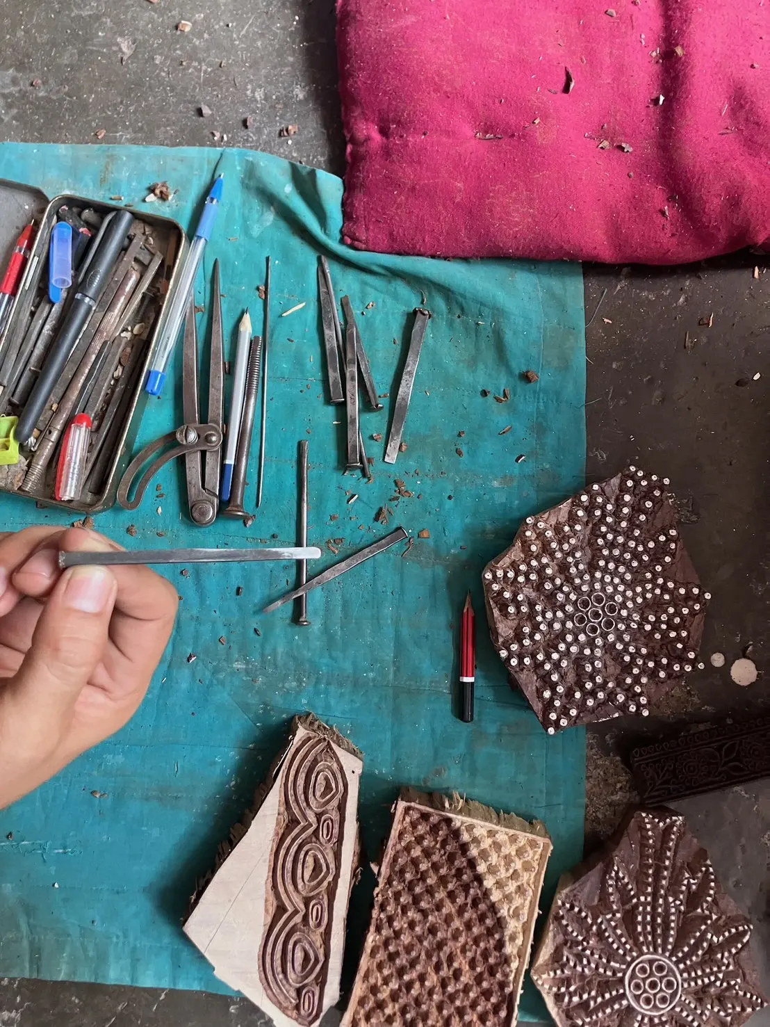 Carving tools and rules on a workbench as a motif is cut into a printing block