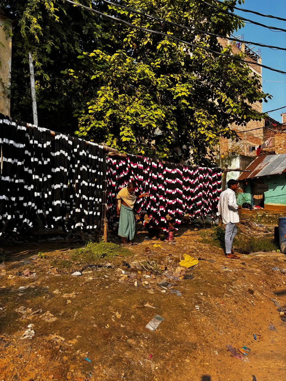 Yarn dyed black and white, hung in layers on an outdoor line to dry