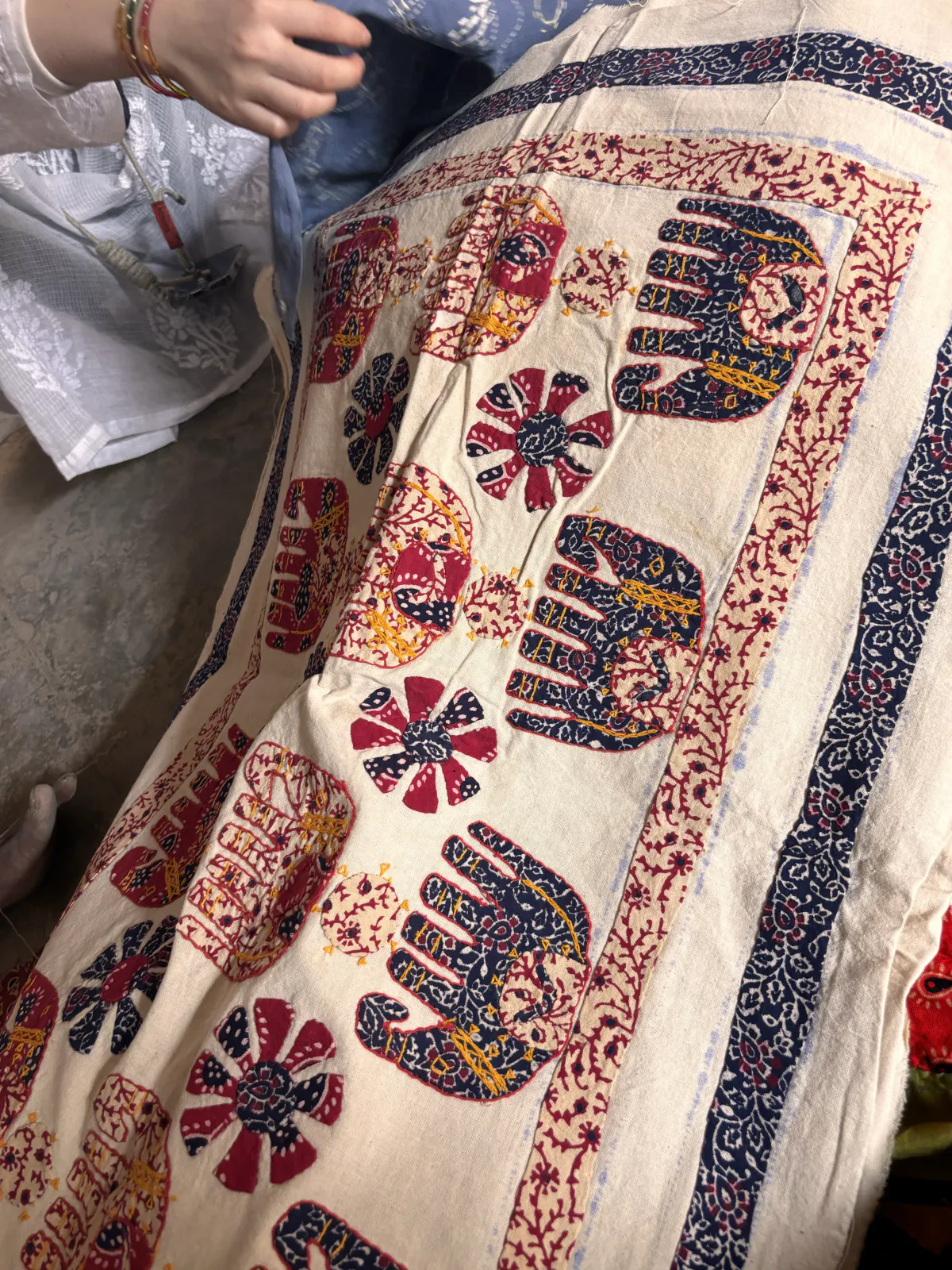 An appliqué throw with elephants and flowers worked in indigo and crimson on undyed cloth