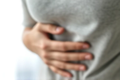 Person feeling discomfort from supplement intake