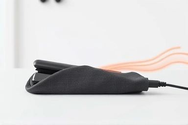 Heat-resistant hair iron pouch safely storing a hot device.