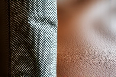 Close-up textures of fabric and leather sofa materials.