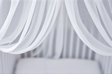 Baby's crib protected by a fine mosquito net