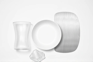 Samples of safe baby dishware materials: Tritan, Ecozen, glass, stainless steel.