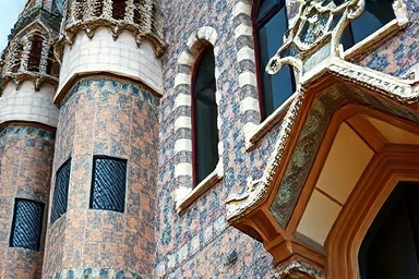 Detailed mosaic art on a Gaudi building in Barcelona.