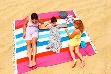 Family enjoying a large, absorbent beach towel on a sunny day.