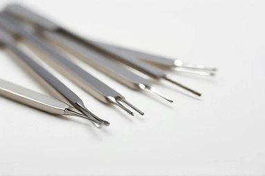High-quality eyelash extension tweezers on a minimalist surface.
