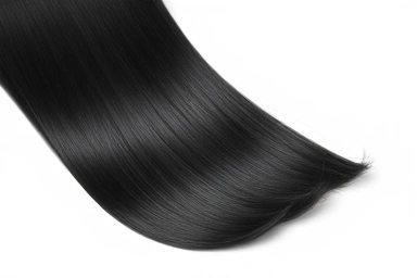 Smooth, glossy, healthy black hair after straightening treatment.