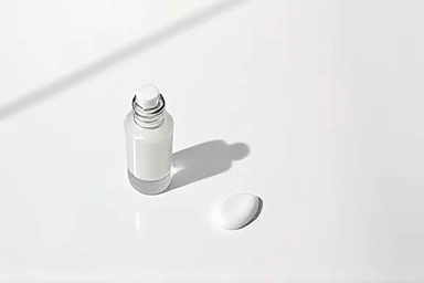 Cosmetic primer product shot, minimal amount emphasized.