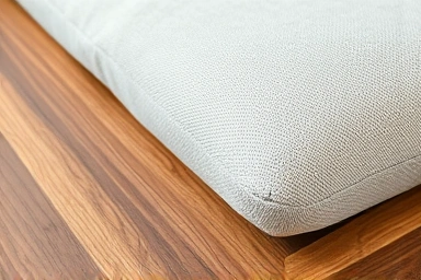 Close-up of diverse bed frame materials: wood, fabric, metal.