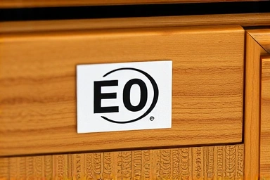 Close-up of E0 grade certification label on wooden furniture.