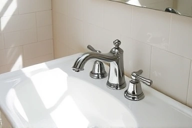 Modern bathroom sink with new faucet, showcasing DIY success.