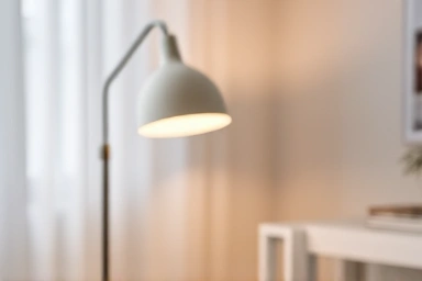 Minimalist Scandinavian room with elegant IKEA Simpliciia lamp.