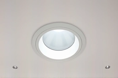 Minimalist ceiling with glare-free pinhole downlights.