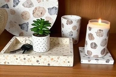 Assortment of terrazzo home decor items on a shelf.