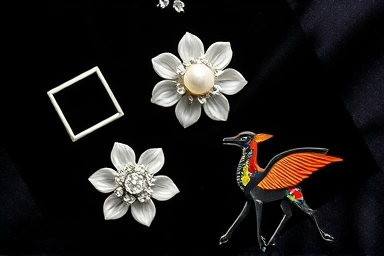Assortment of stylish brooches on velvet fabric, fashion accessory collection.