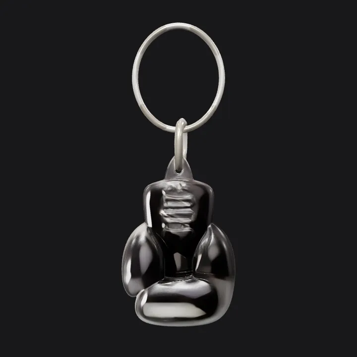 Boxing glove keychain, black color. smooth edges, simple geometry, game-ready.