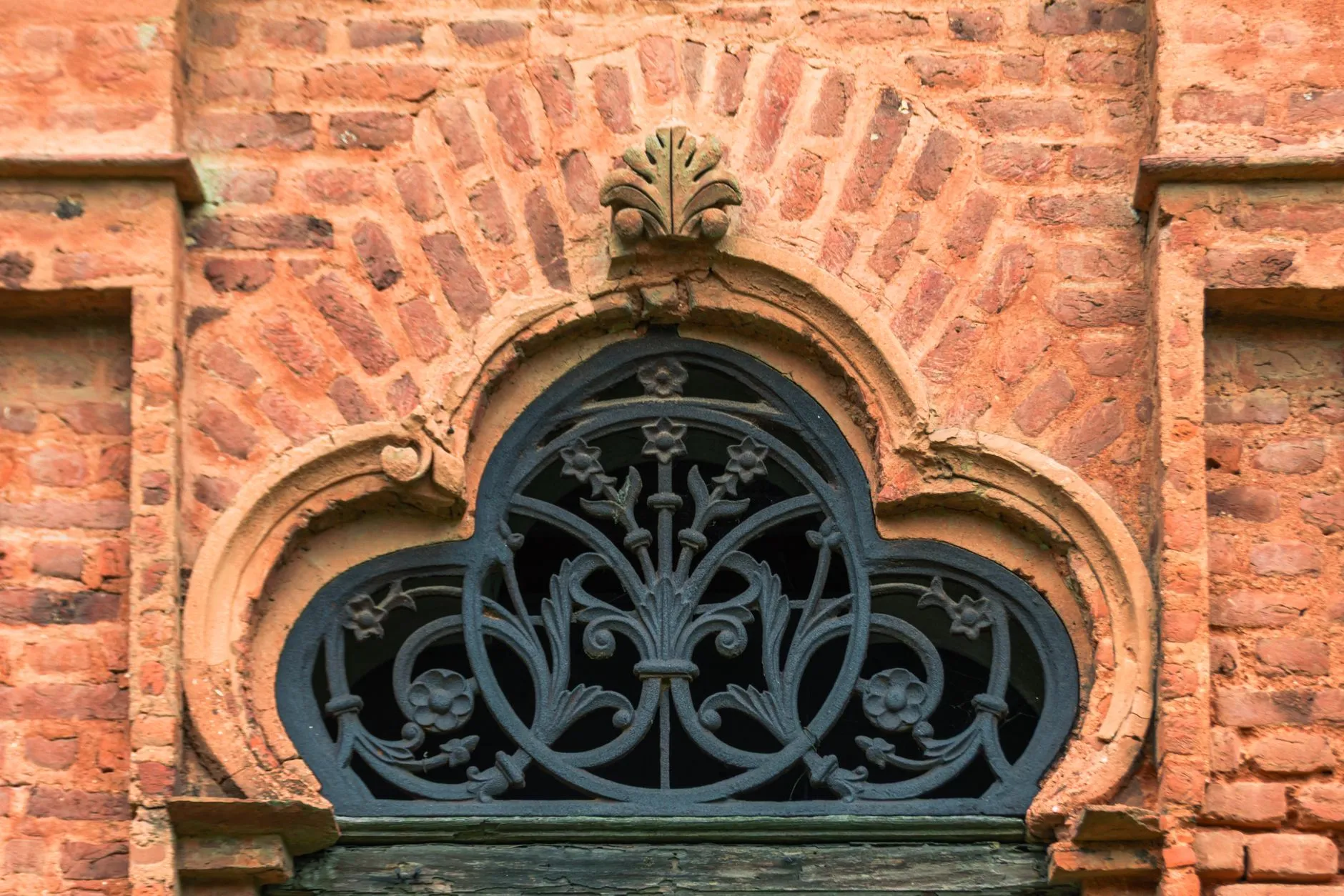 a detail of restored historic ironwork and brick in Charleston