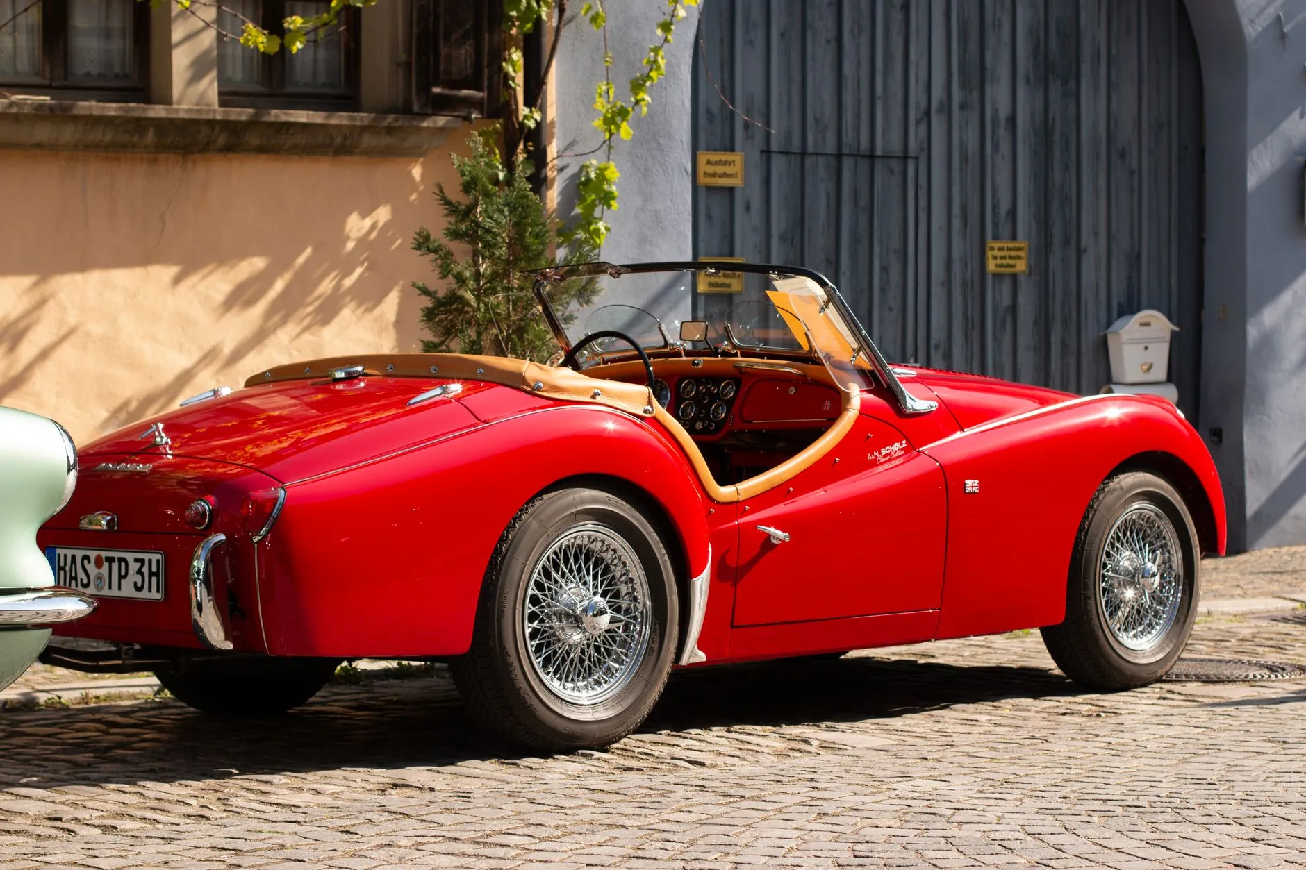 a beautifully restored vintage convertible in the sun