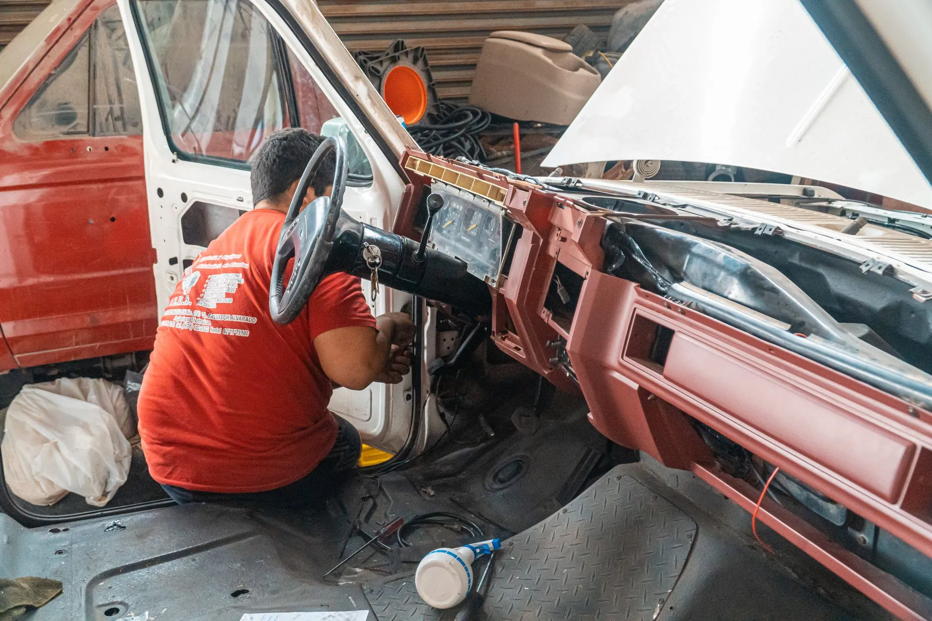 a skilled auto body technician repairing a car panel in a professional collision shop