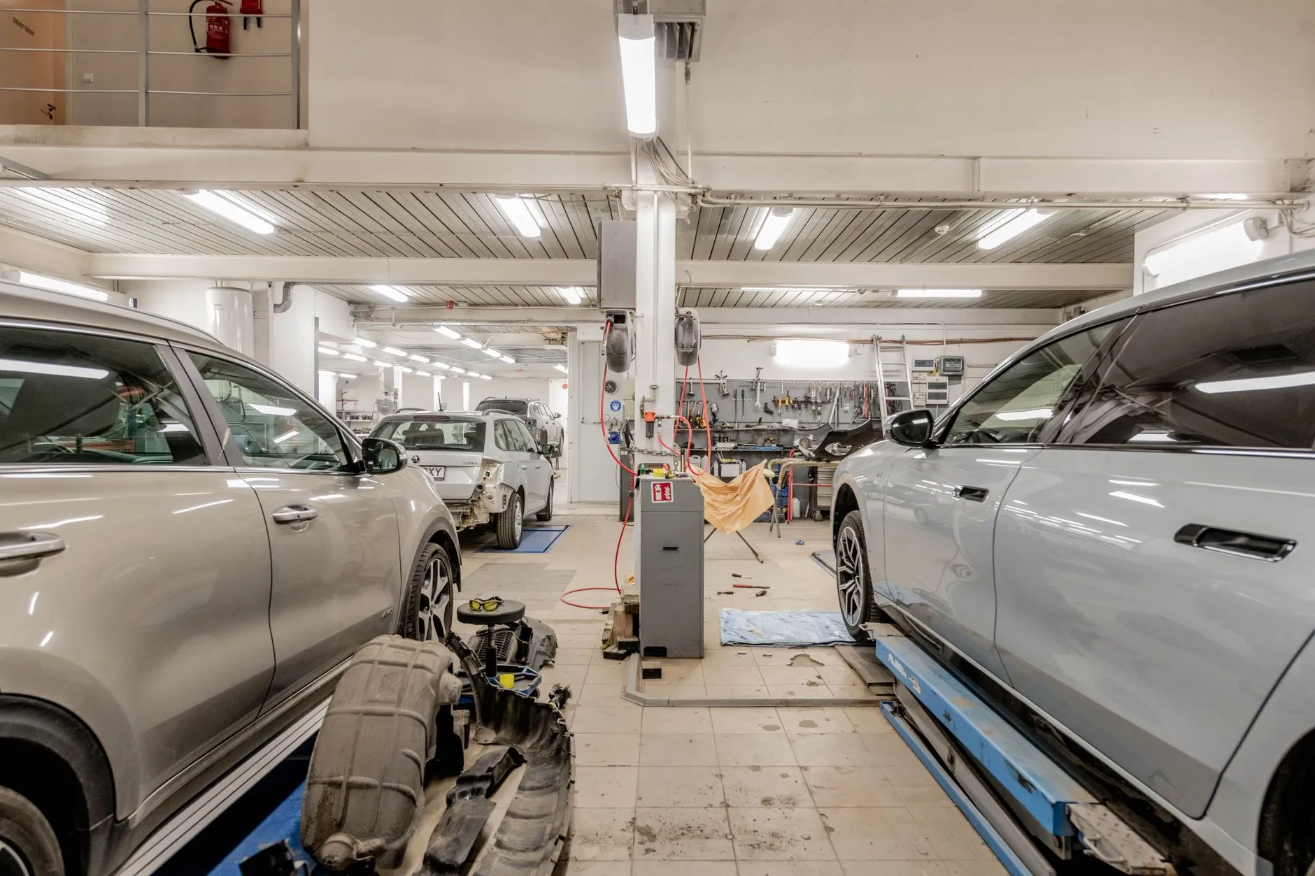 a clean organized modern import auto repair shop with cars