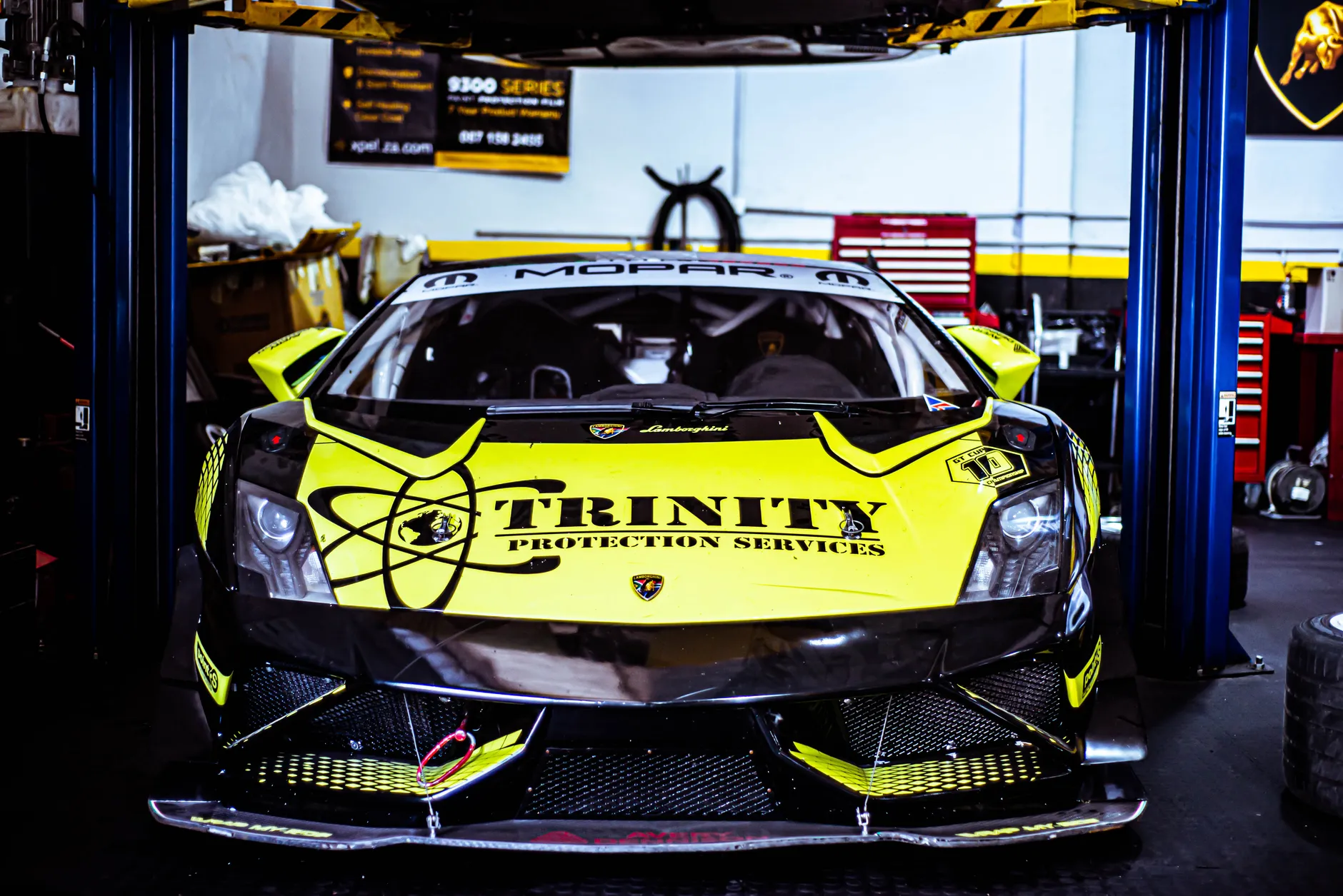 a performance sports car on a dynamometer in a tuning shop