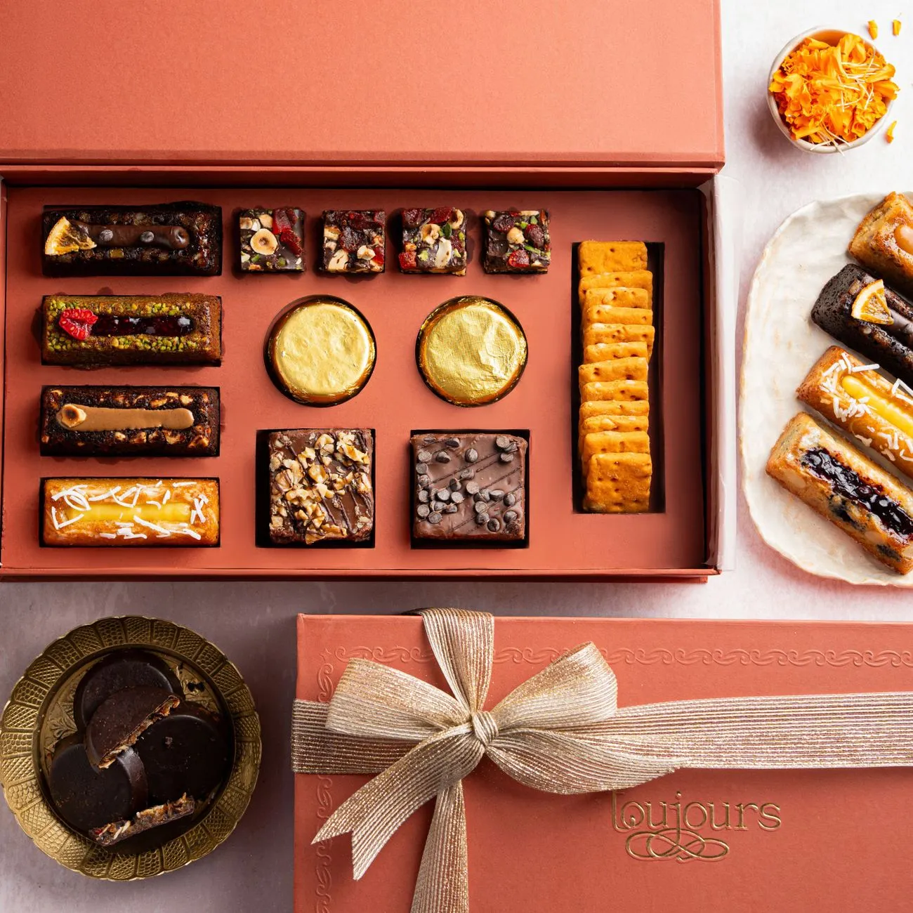 an assortment box of elegant French petits gateaux