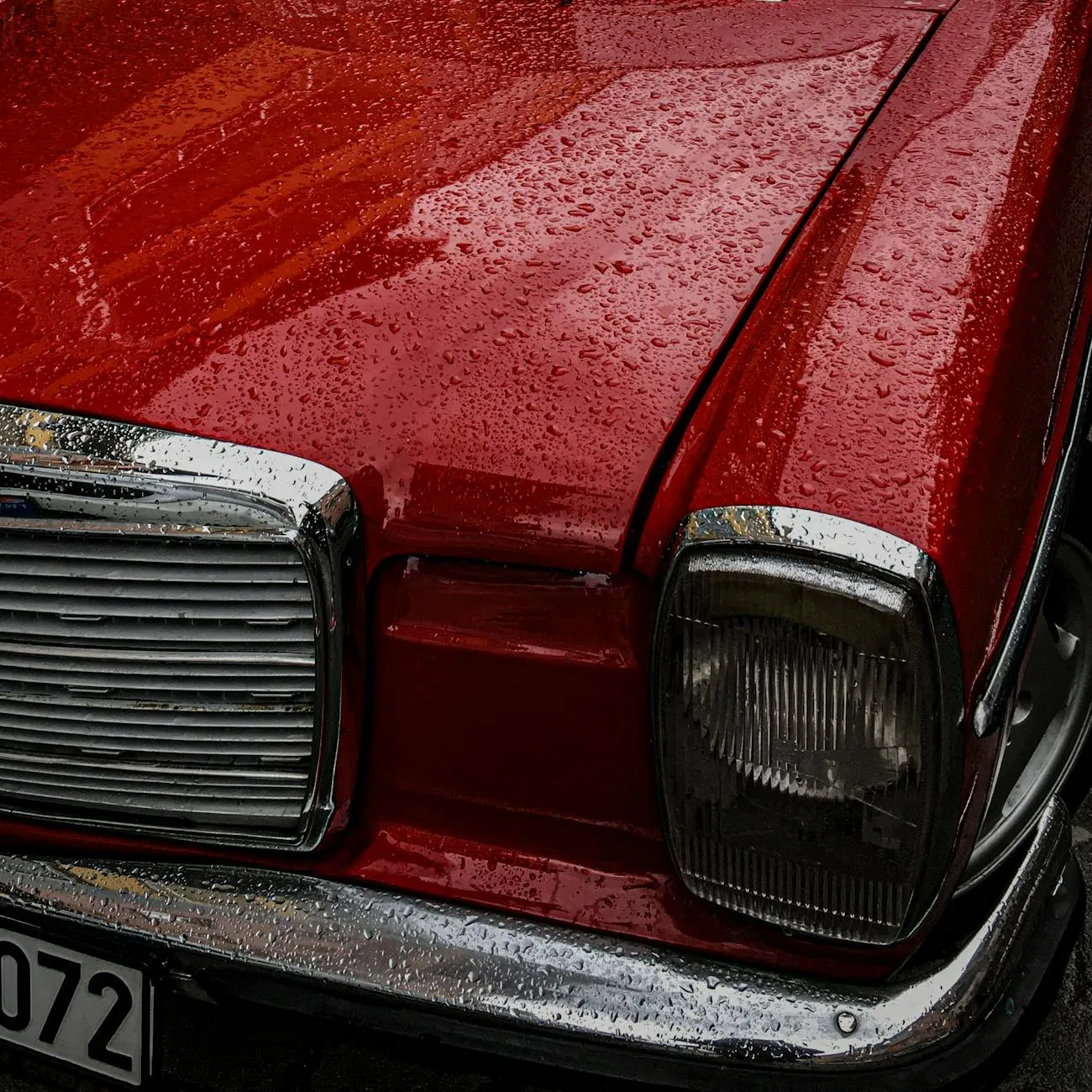Water droplets beading on a freshly waxed car hood