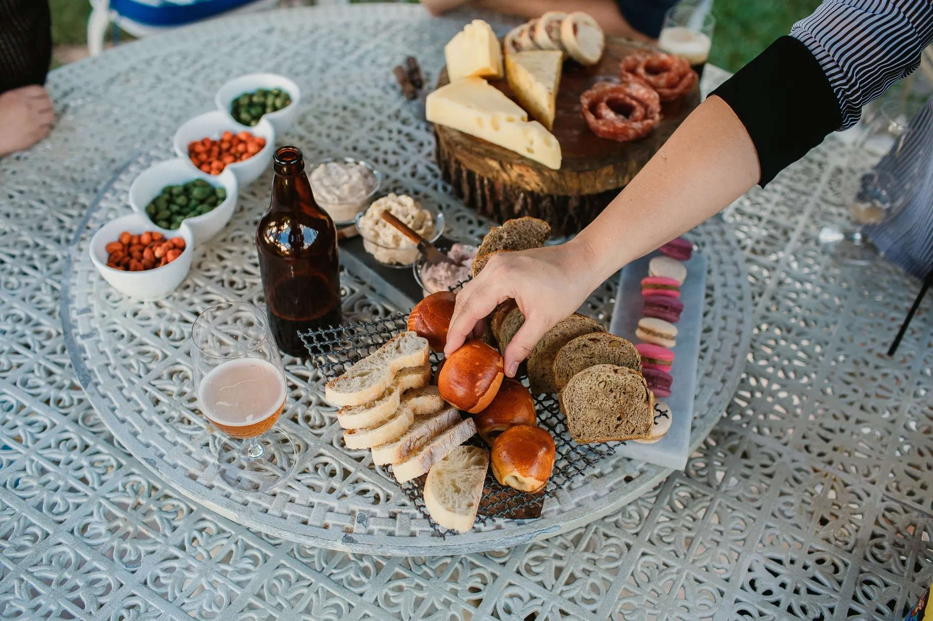 guests reaching for bites from a styled grazing spread